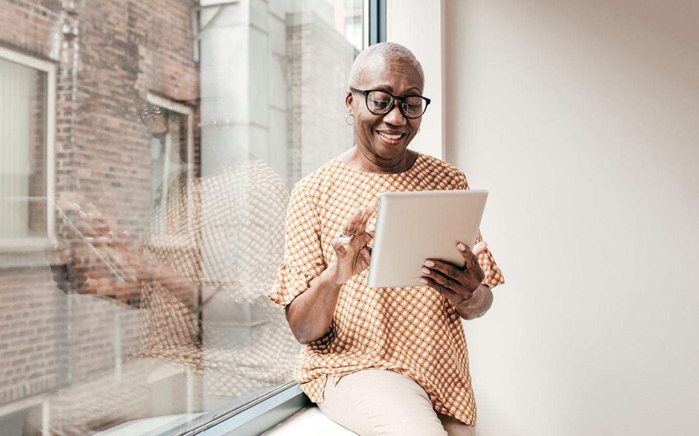 Woman scrolling on tablet